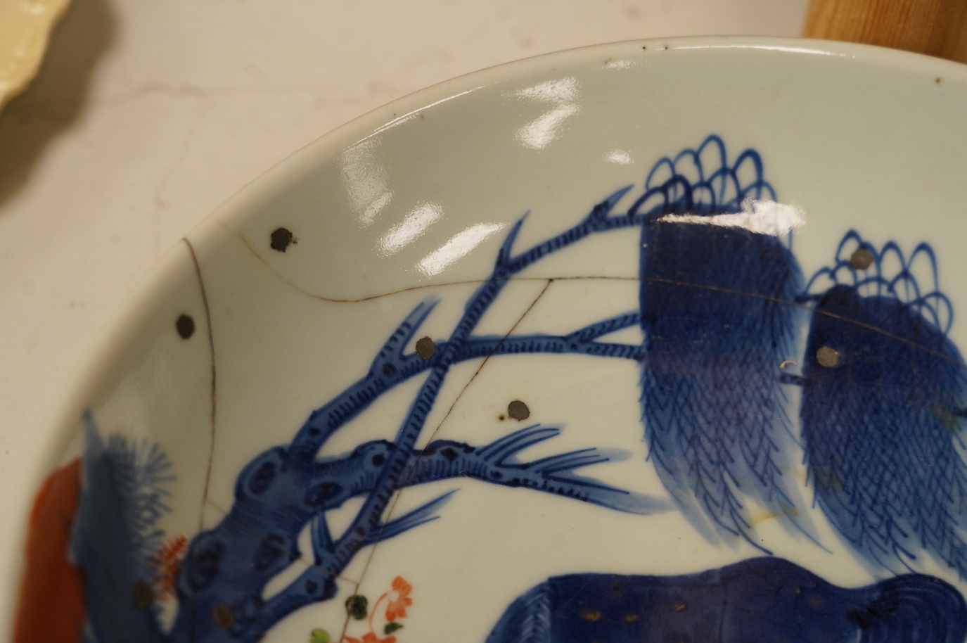 A Chinese underglaze blue and red and green enamelled 'horses' dish, Yongzheng period, 28.5cm. Condition - poor